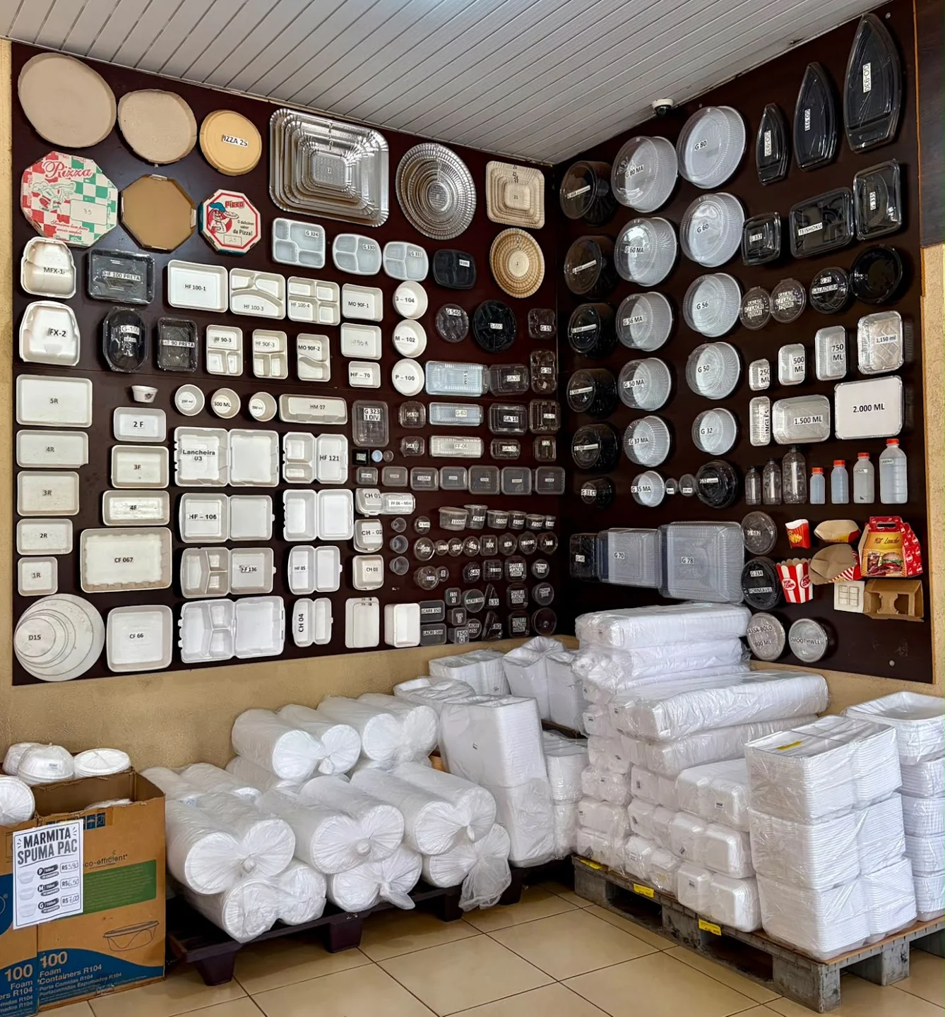 Interior da loja Riber Plast com modelos de embalagens expostos e produtos nas prateleiras